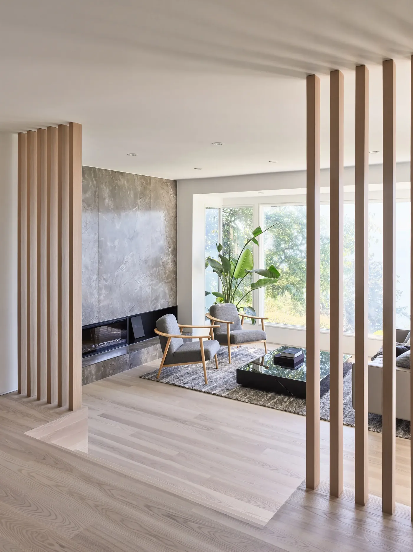 Living room with fireplace and slatted wood dividers